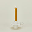 Foundry Candlestick with lit candle 