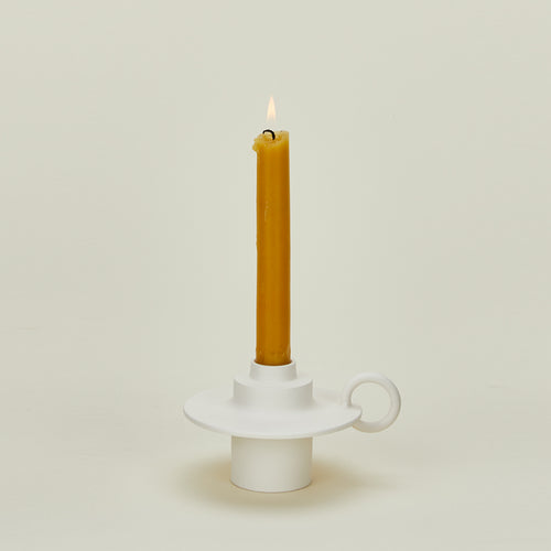 Foundry Candlestick with lit candle 