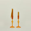 Pleated candle holders in amber with tapers