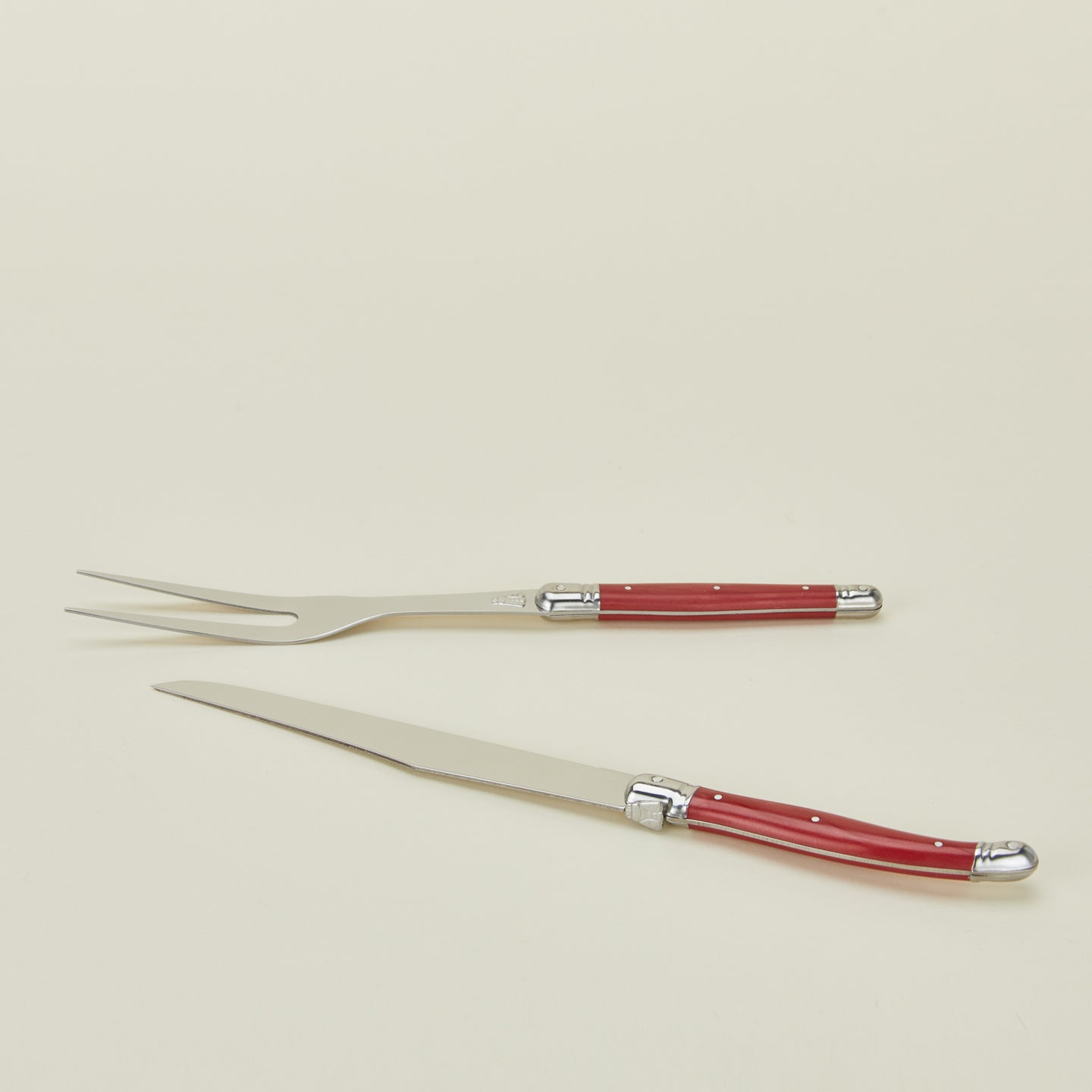 Close up view of Jean Dubost carving set in red