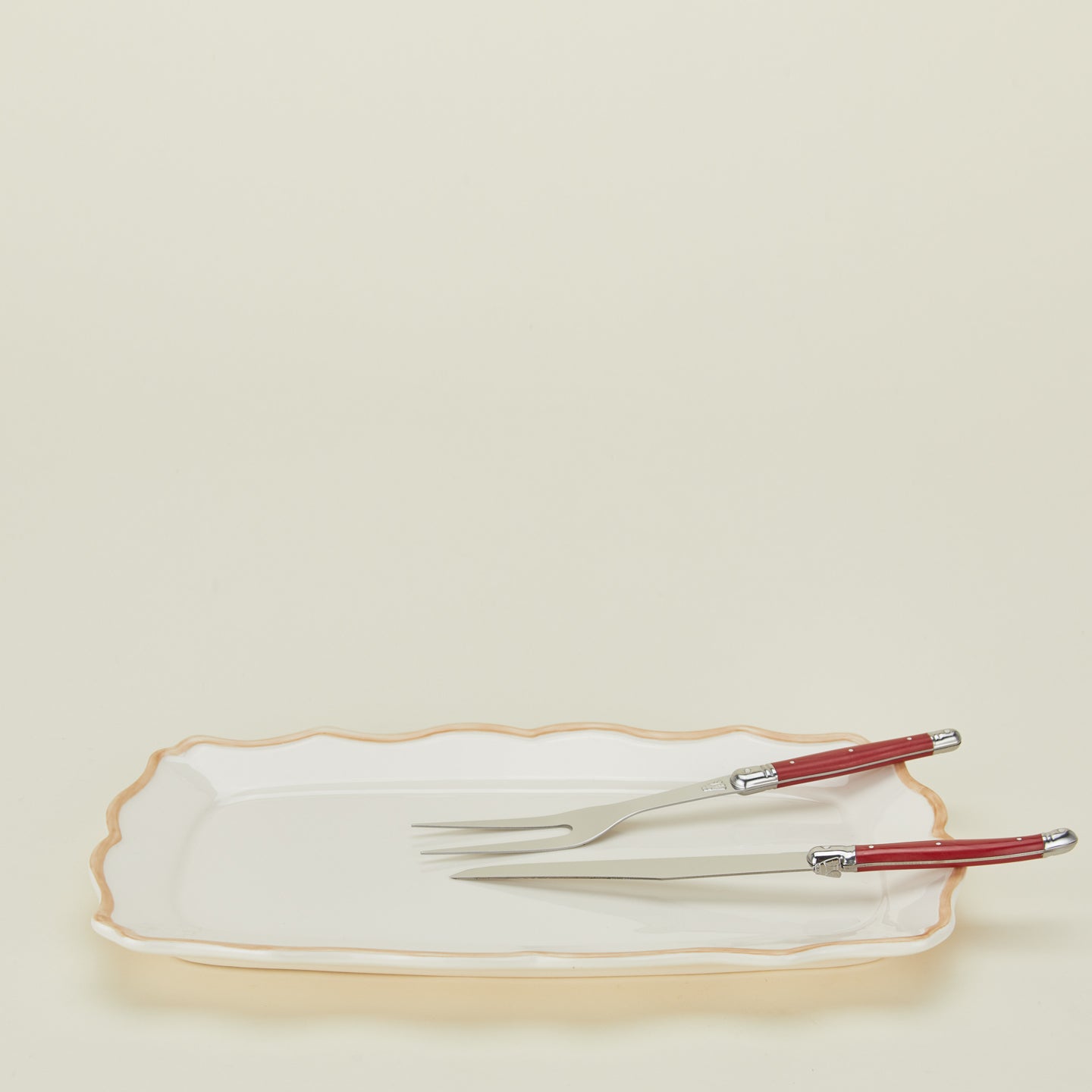 Jean Dubost carving set in red on a rectangular platter