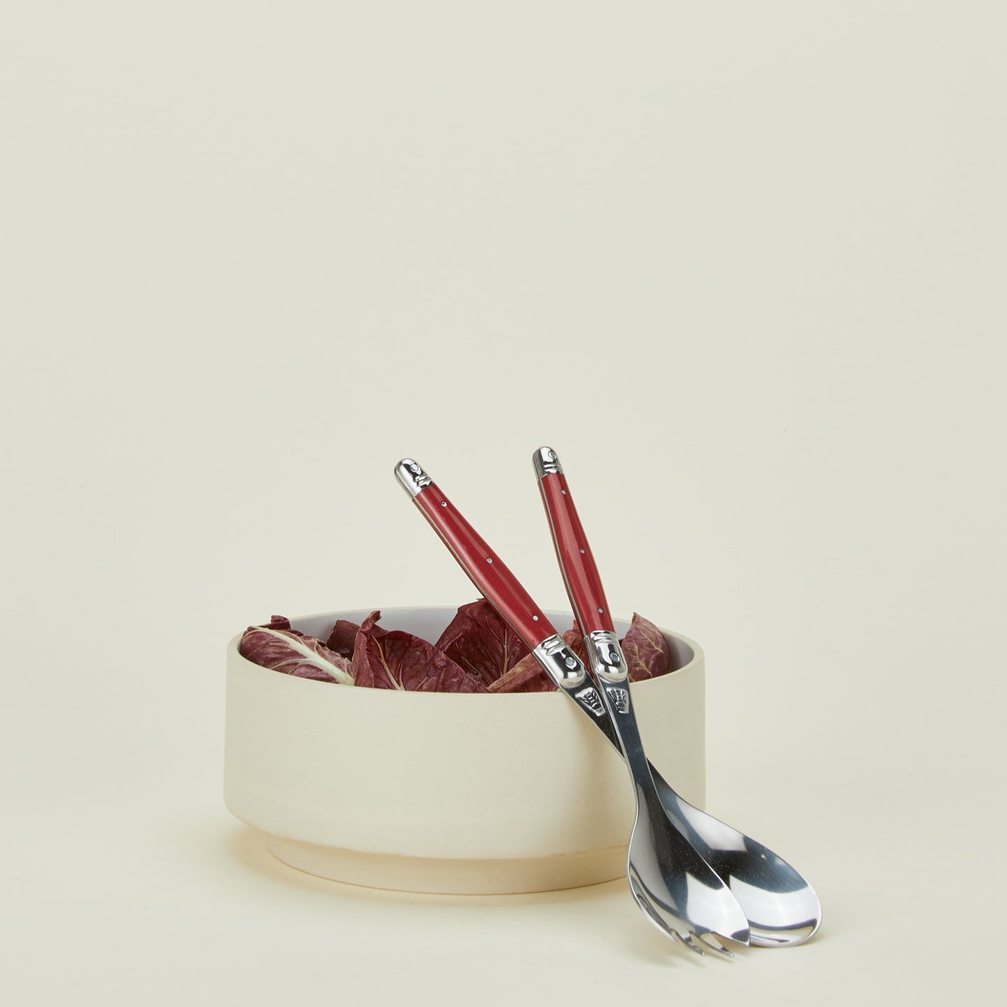 Jean Dubost salad servers in red with salad in a bowl