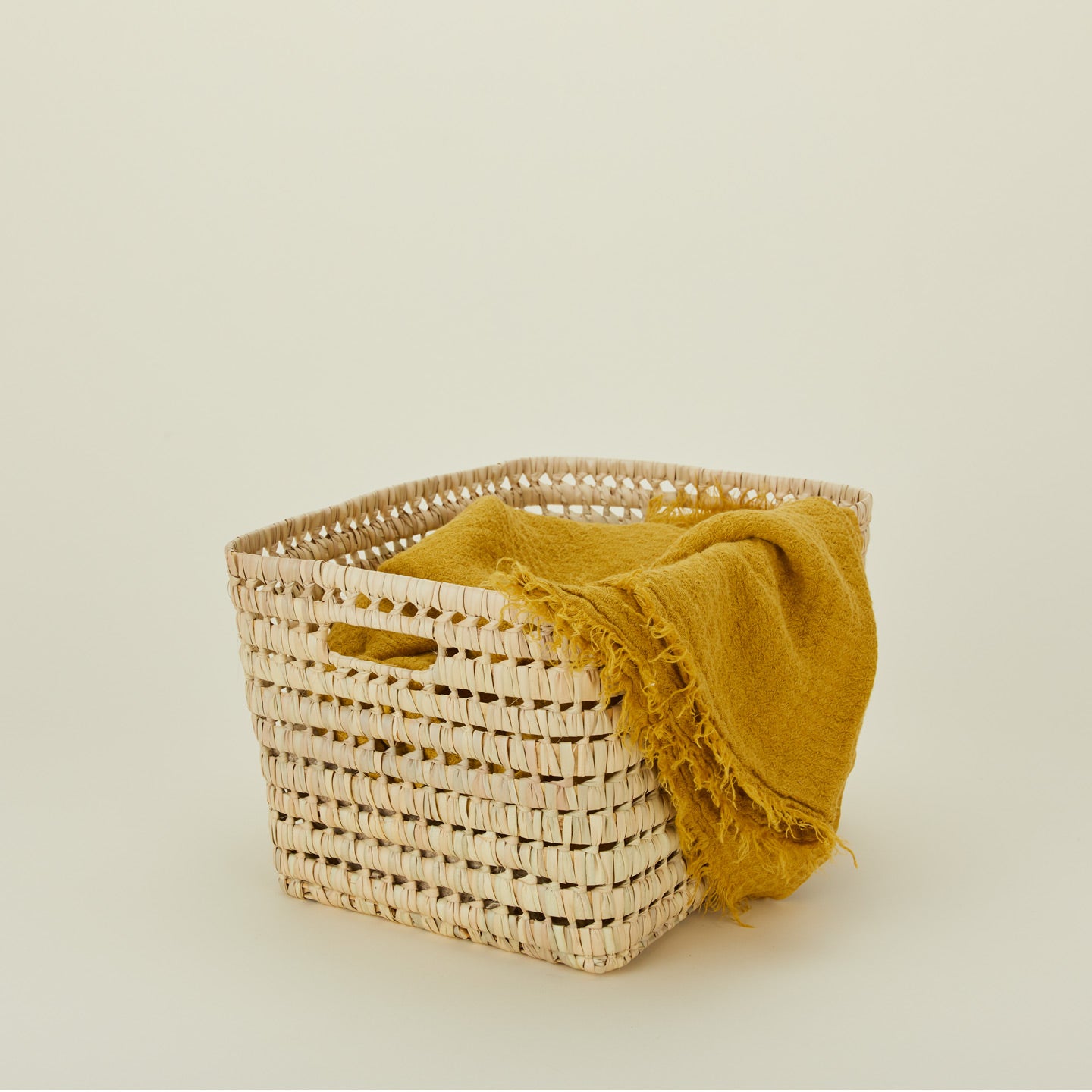 Large open weave basket with mustard blanket