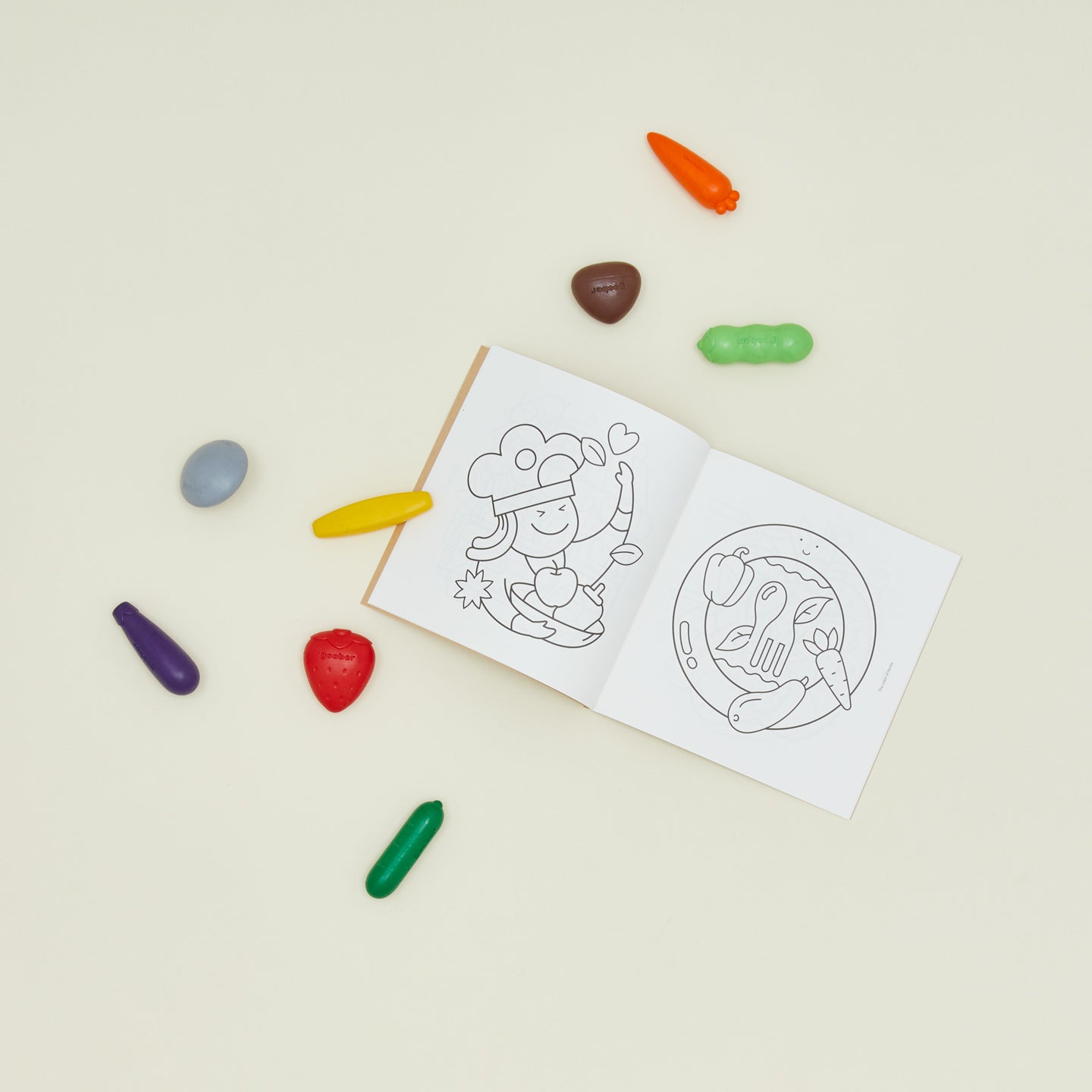 Crayons in the shape of fruits and vegetables with coloring book