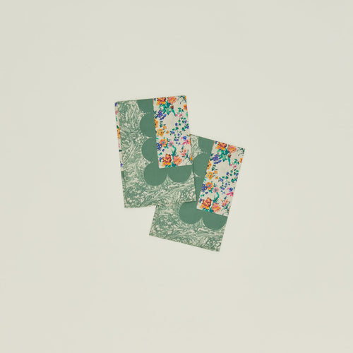A set of two mixed floral napkins with a fern pattern.