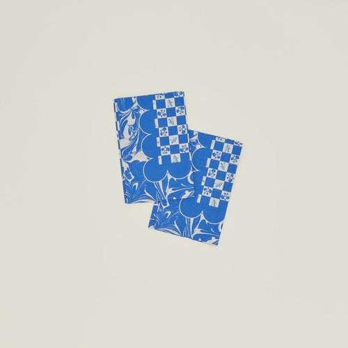 A set of two mixed floral napkins with a klein blue pattern.