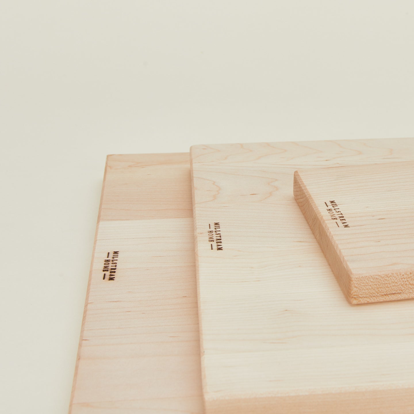 Close up view of scalloped cutting boards in all 3 sizes