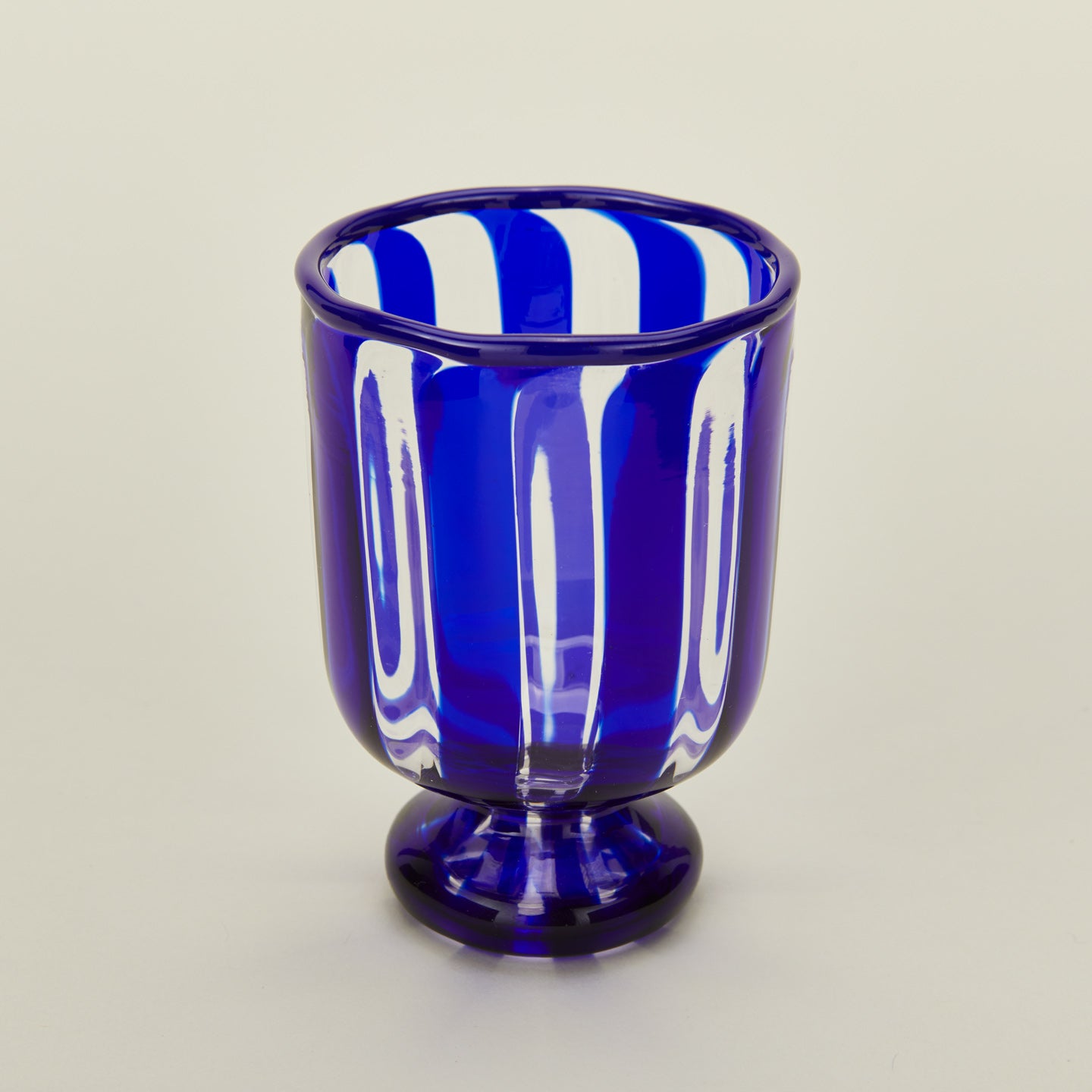 Close up view of blue striped wine glass