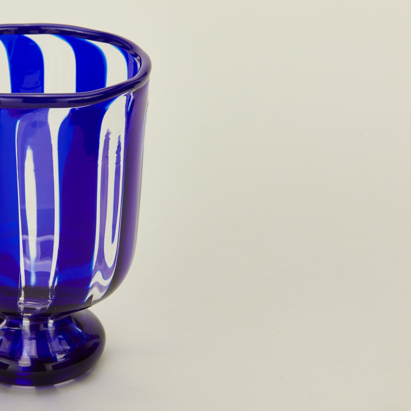 Close up view of blue striped wine glass