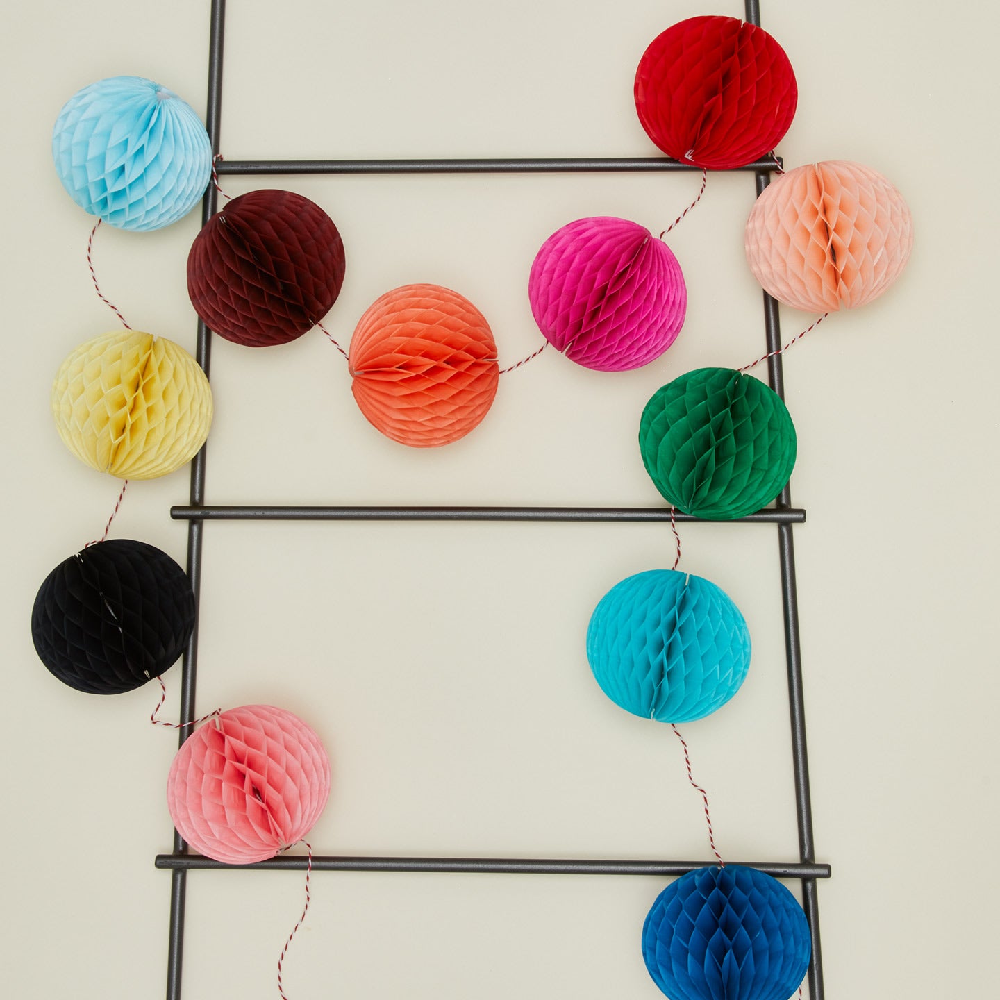 Petra Boase bunting ball garland on ladder