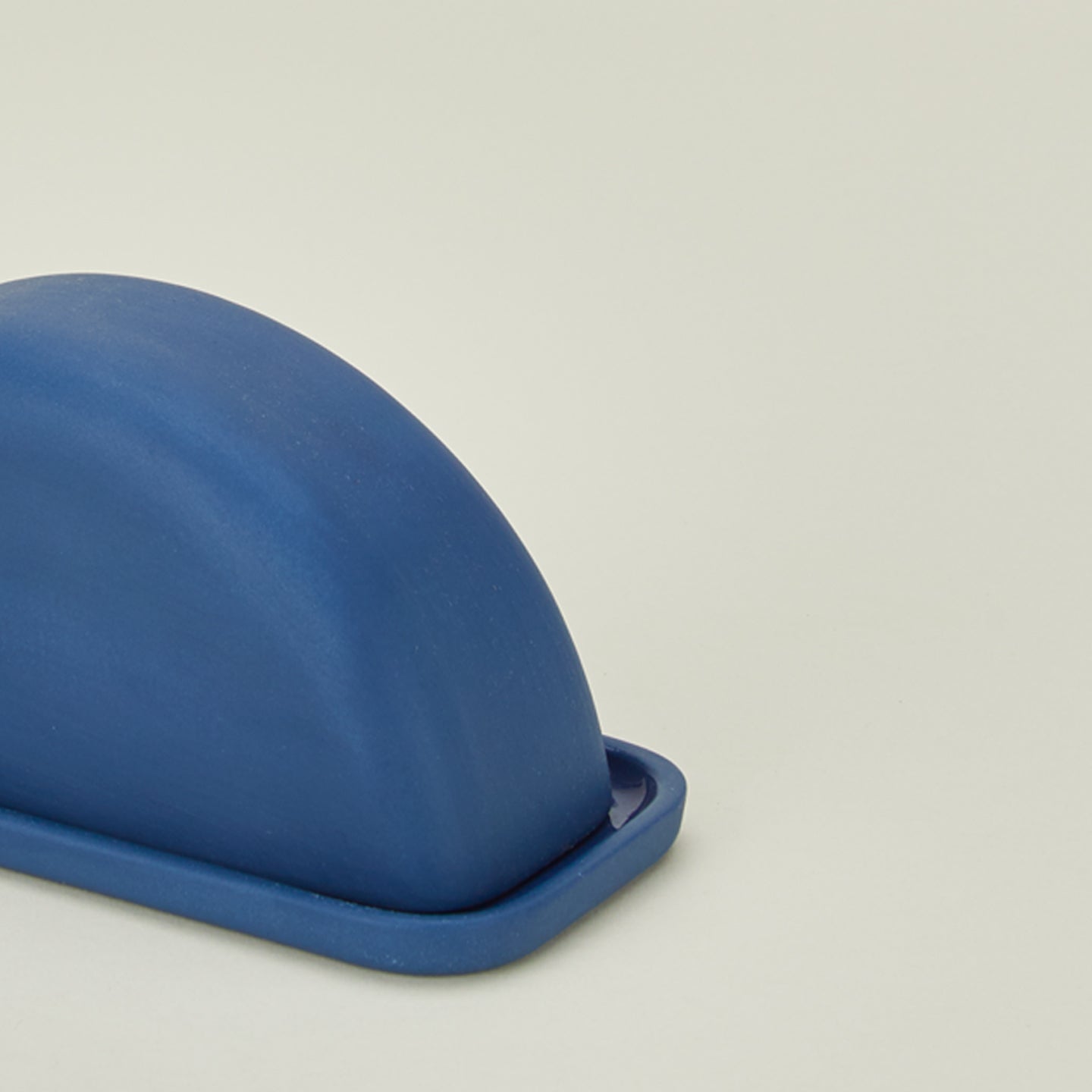 Close up view of Curve butter dish in azure