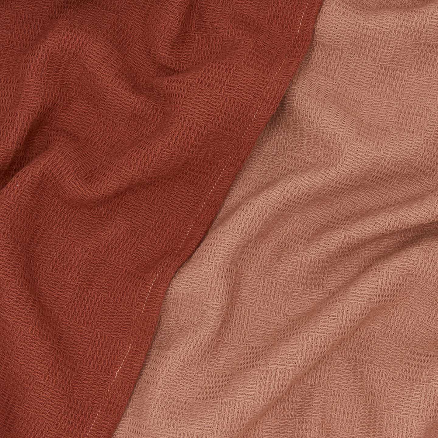 Close up view of woven stripe kitchen towels in blush and terracotta