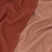 Close up view of woven stripe kitchen towels in blush and terracotta