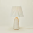 Pleat table lamp in bone with ivory shade