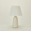 Pleat table lamp in bone with ivory shade