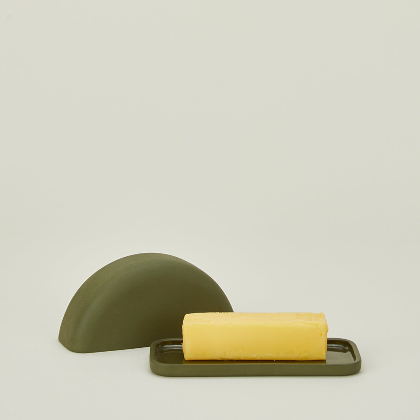 Curve butter dish in moss with lid off and stick of butter