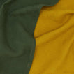 Close up view of woven stripe kitchen towels in mustard and olive
