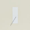 A6 grid notepad open with slim pen