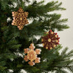 Quilled snowflake ornaments in warm on tree