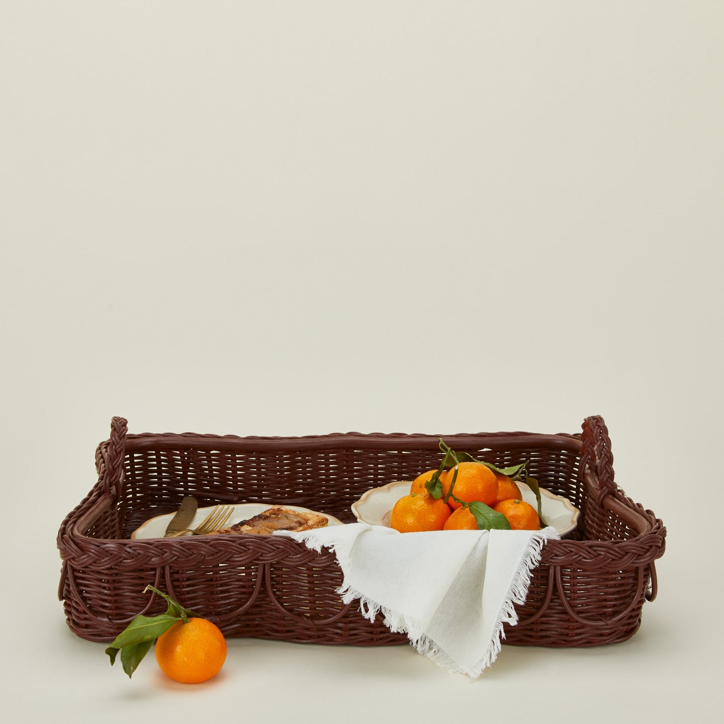 Hadley tray in berry with plate, food, oranges, and a napkin.