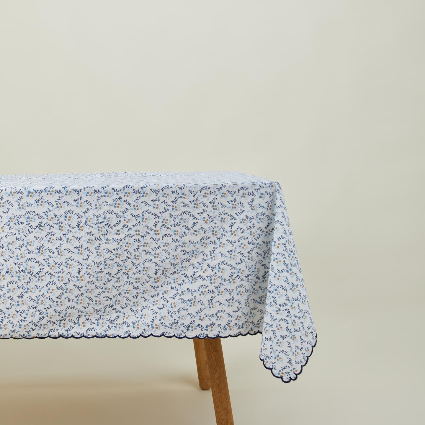 Little flowers rectangular tablecloth in blue on table.