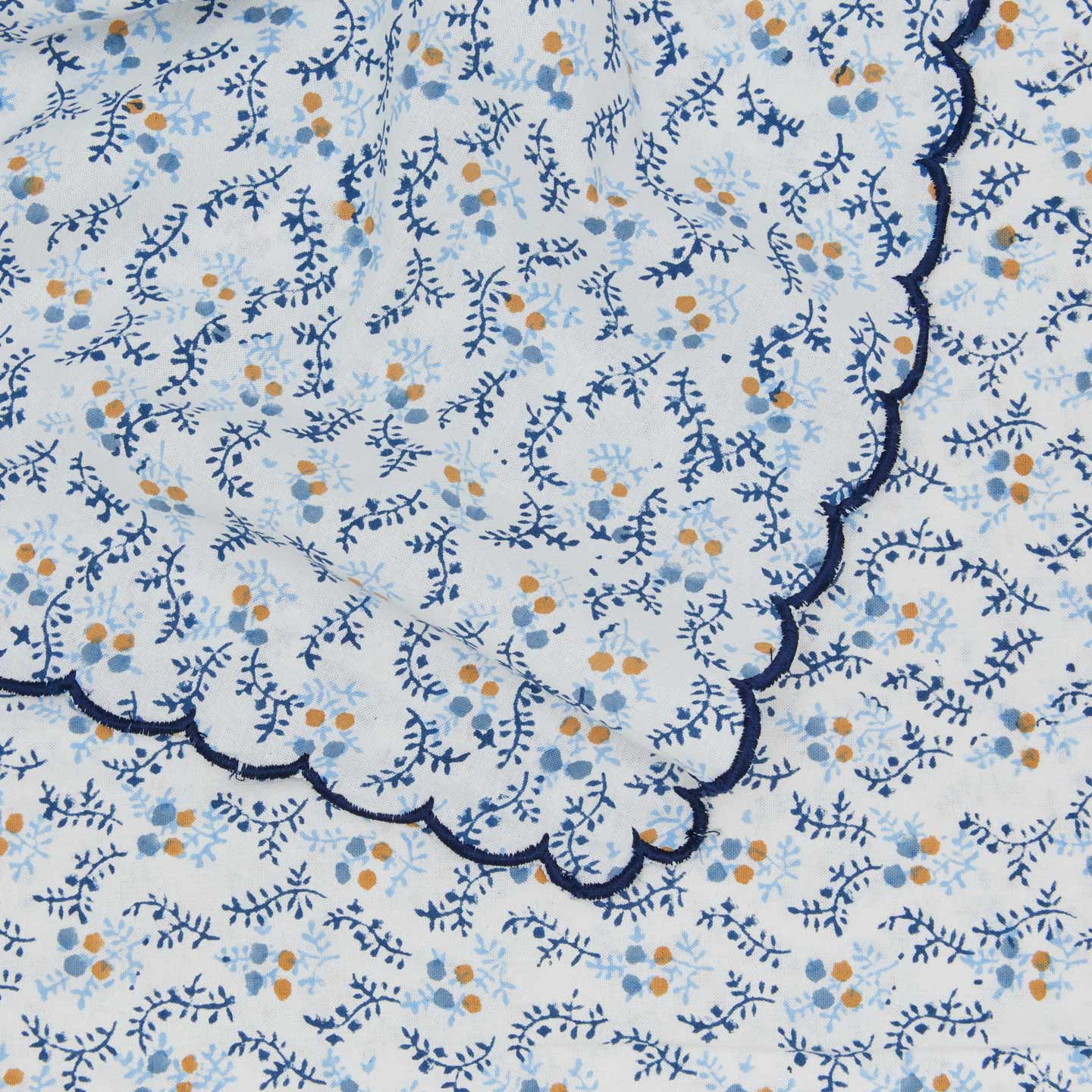 Close up view of little flowers rectangular tablecloth in blue.
