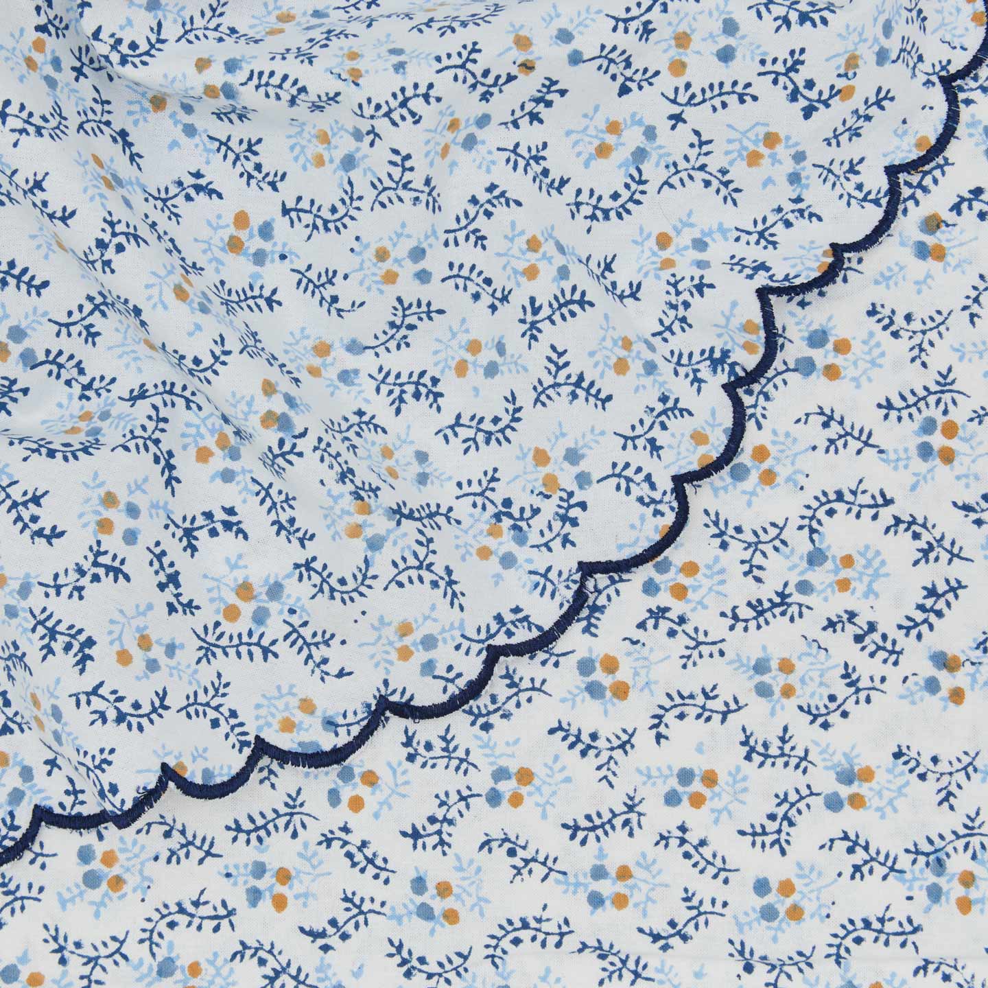 Close up view of round little flowers tablecloth in blue