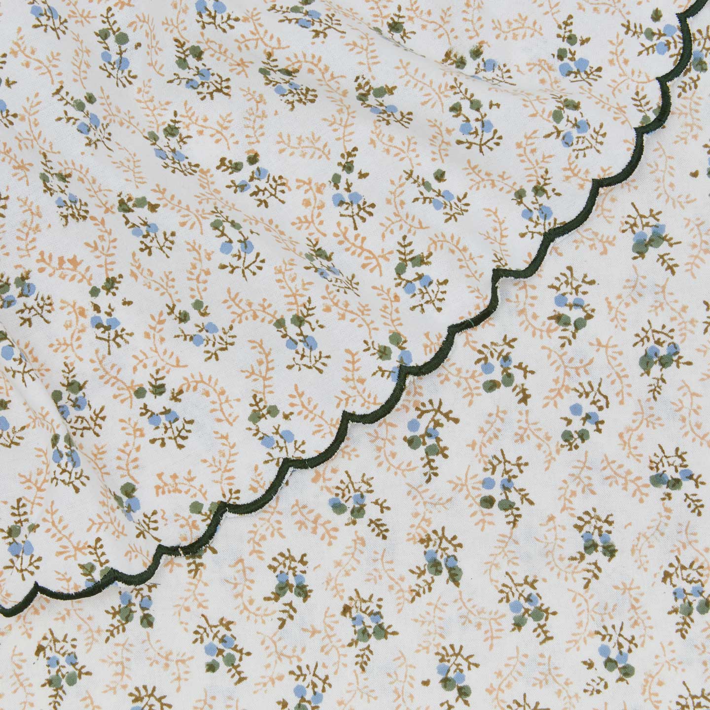 Close up view of little flowers tablecloth in green