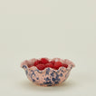Splatter scallop bowl in pink and blue with raspberries
