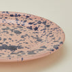 Close up view of Splatter dinner plate in pink and blue