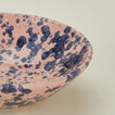 Close up view of Splatter low bowl in pink and blue