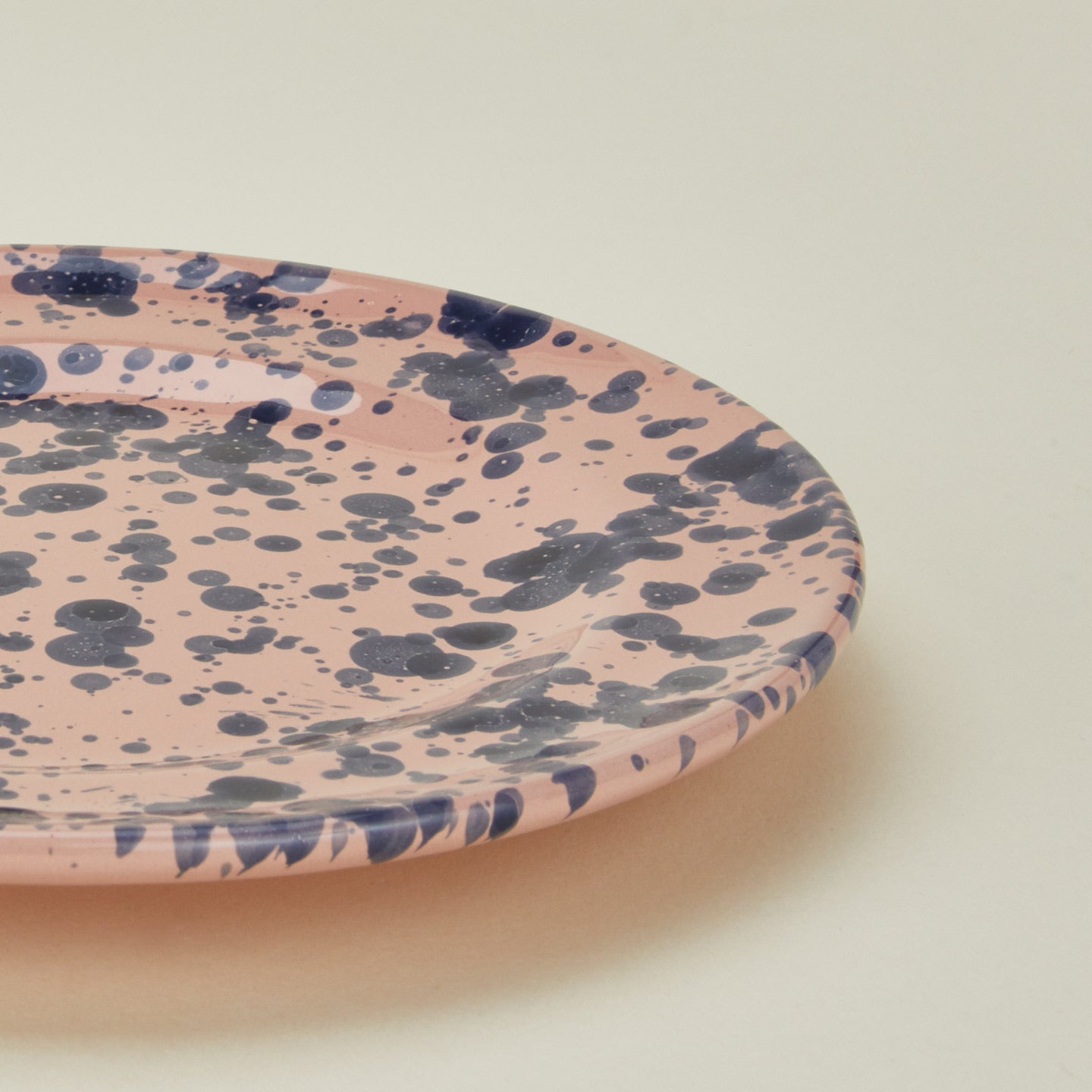 Close up view of splatter salad plate in pink and blue