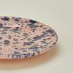 Close up view of splatter salad plate in pink and blue