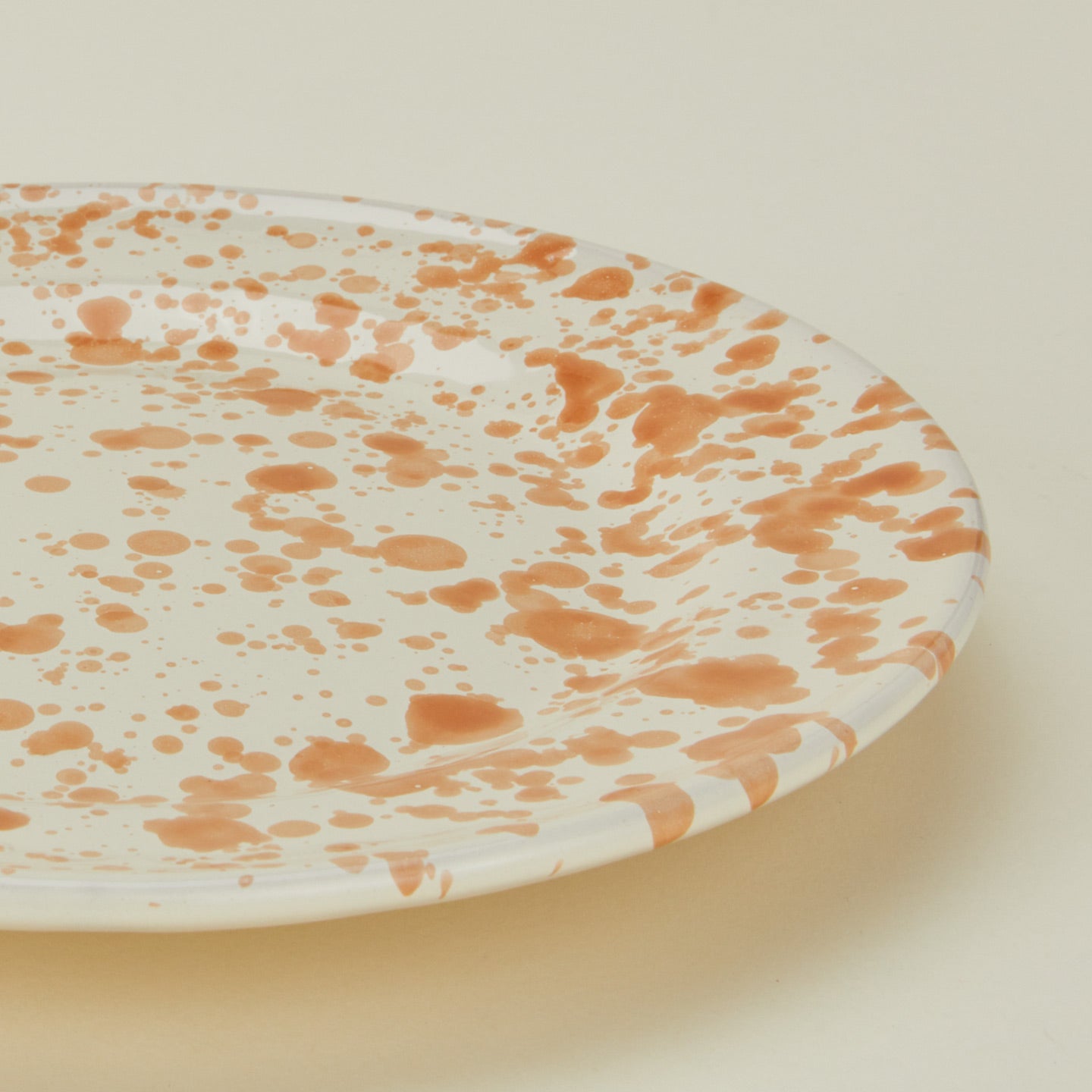 Close up view of Splatter dinner plate in tan and ivory