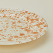 Close up view of Splatter dinner plate in tan and ivory
