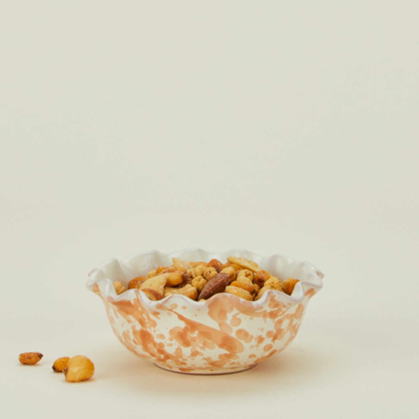 Splatter scallop bowl in tan and ivory with snack mix