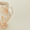 Close up view of tan and ivory vase