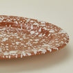Close up view of Splatter terracotta and ivory oval platter 