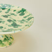 Close up view of Splatter cake stand in yellow and green