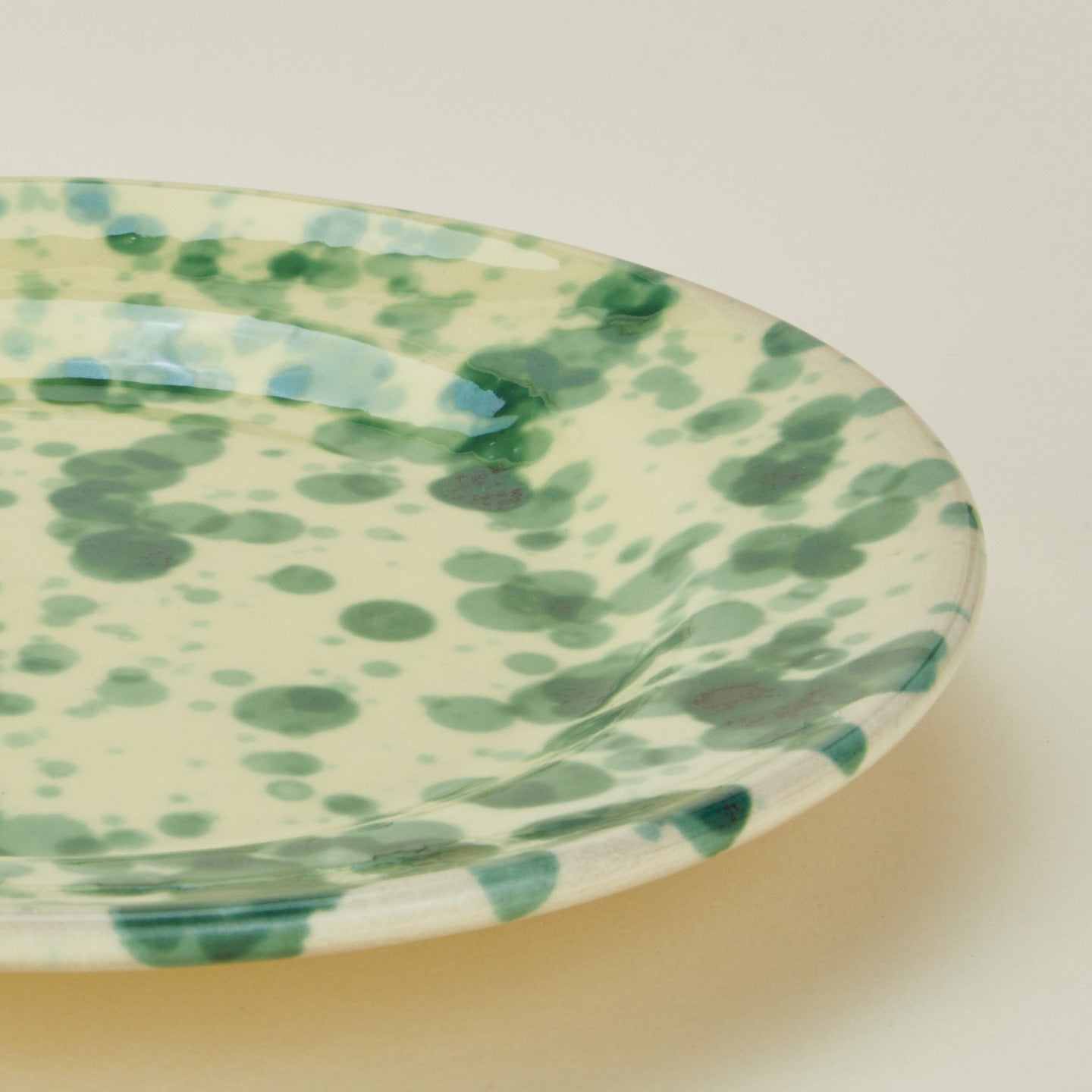 Close up view of Splatter dinner plate in yellow and green