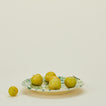 Splatter dinner plate in yellow and green with apples