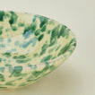 Close up view of Splatter low bowl in yellow and green