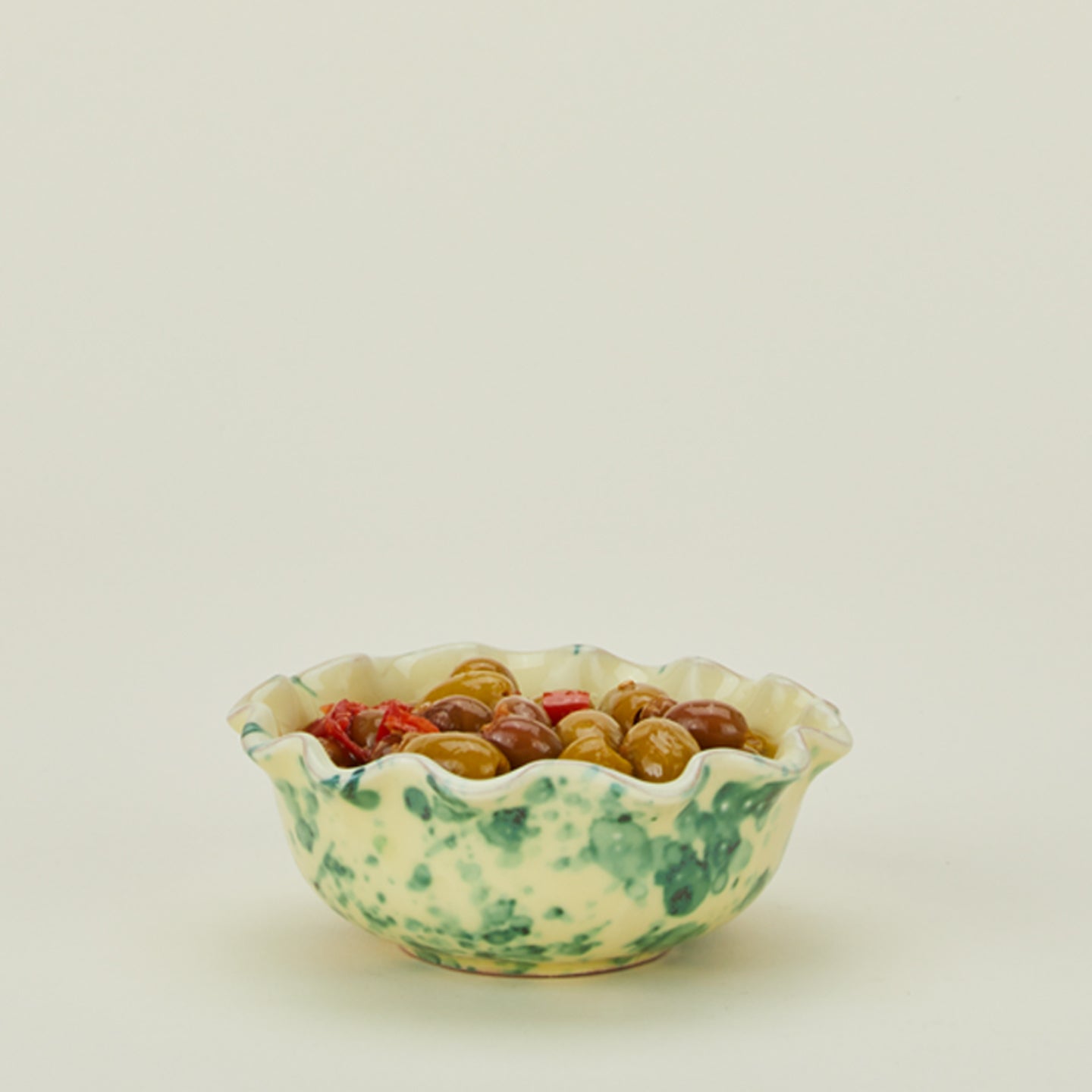 Splatter scallop bowl in yellow and green with olives