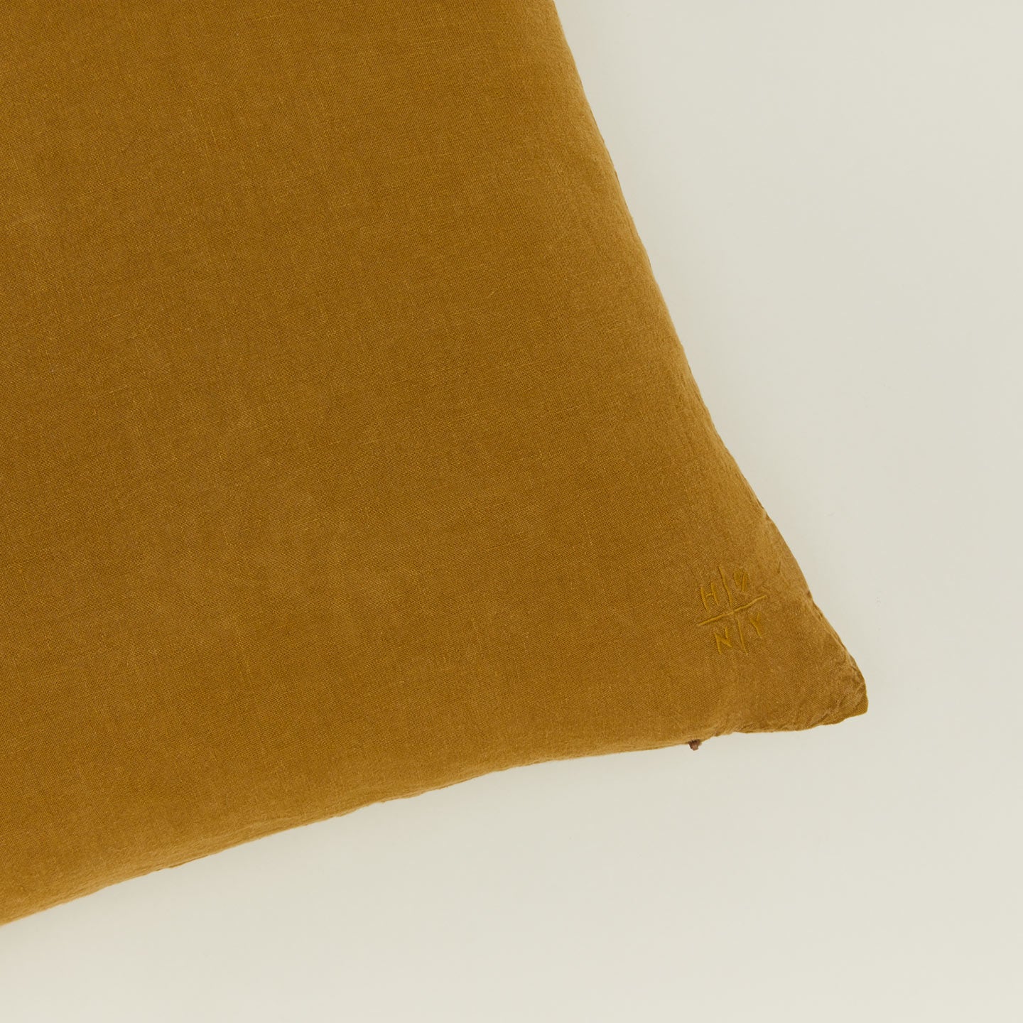 Close up view of simple linen pillow in bronze