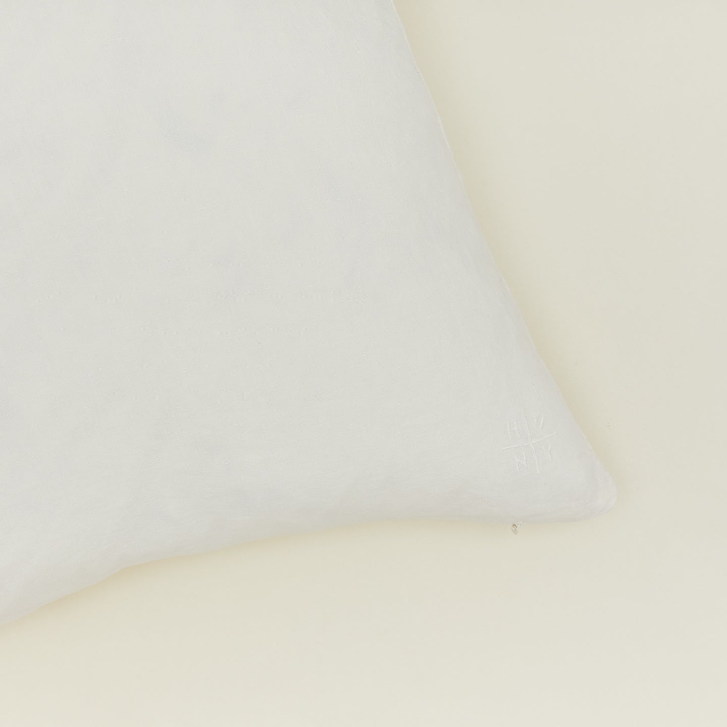 Close up view of simple linen pillow in ivory
