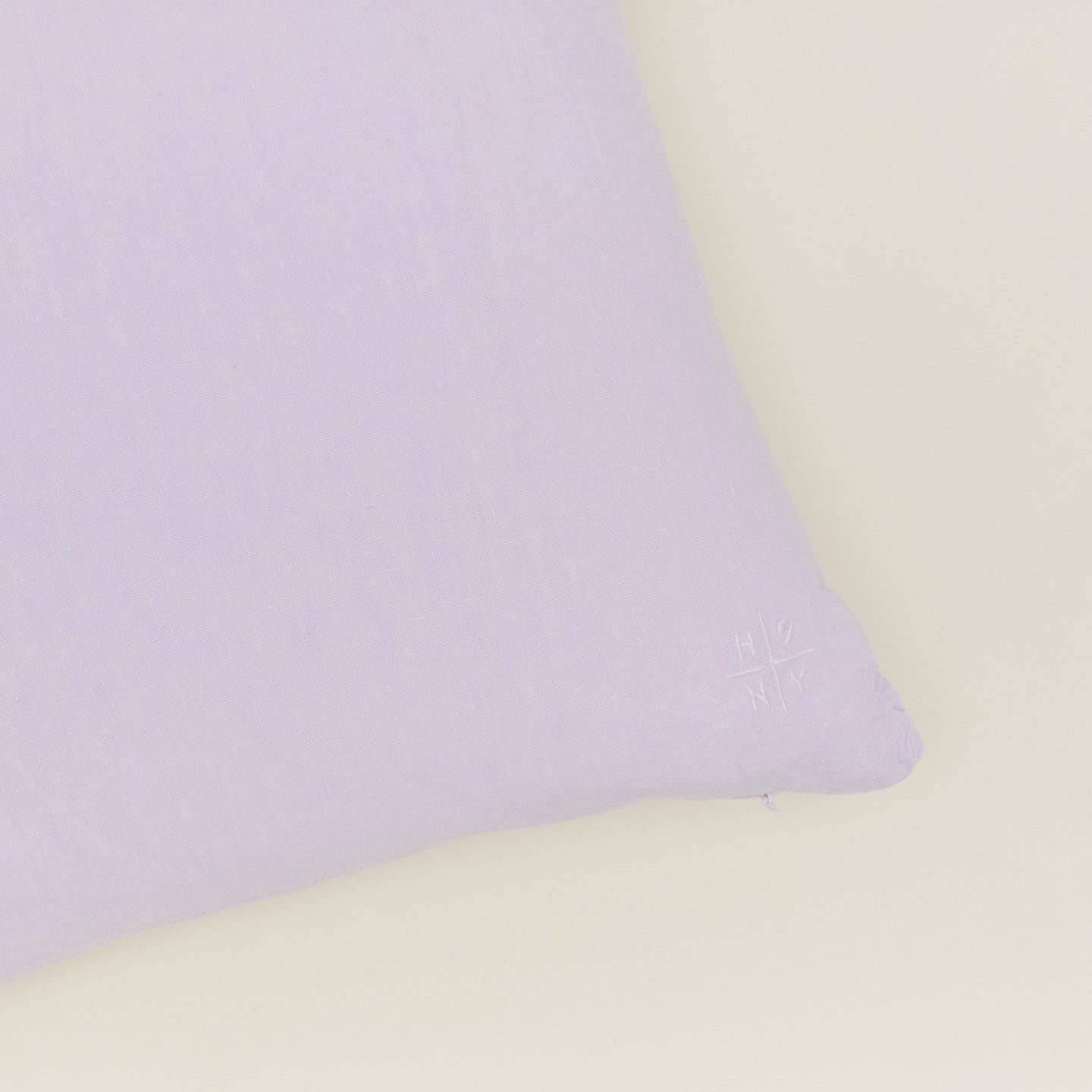 Close up of simple linen pillow in lilac