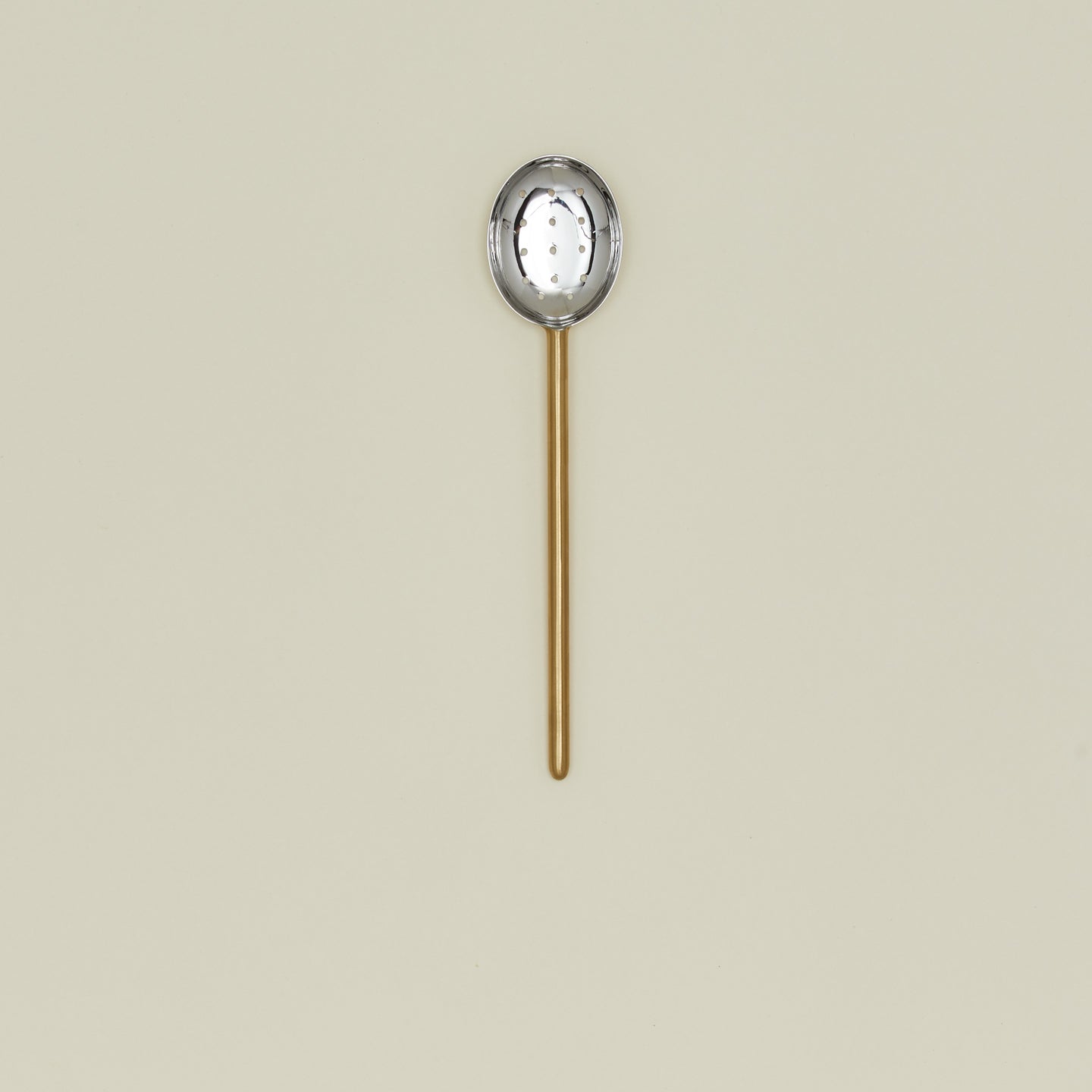 Simple metal slotted spoon in brass