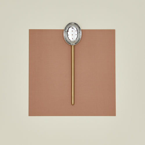 Simple metal slotted spoon in brass