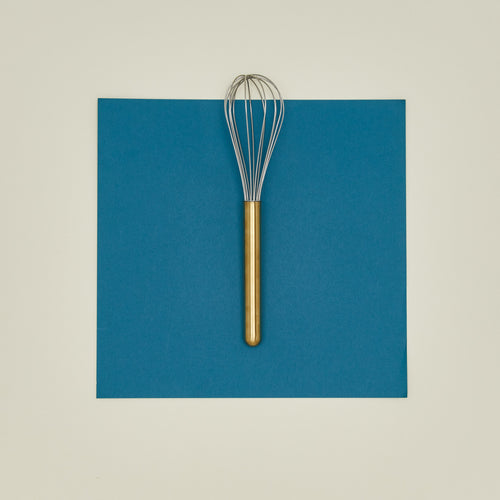 Simple metal whisk in brass