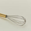 Close up view of Simple metal whisk in brass